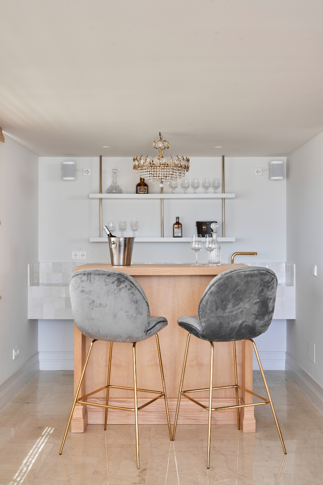 Bar at Terraza Del Sol — velvet stools, gold legs, crystal chandelier