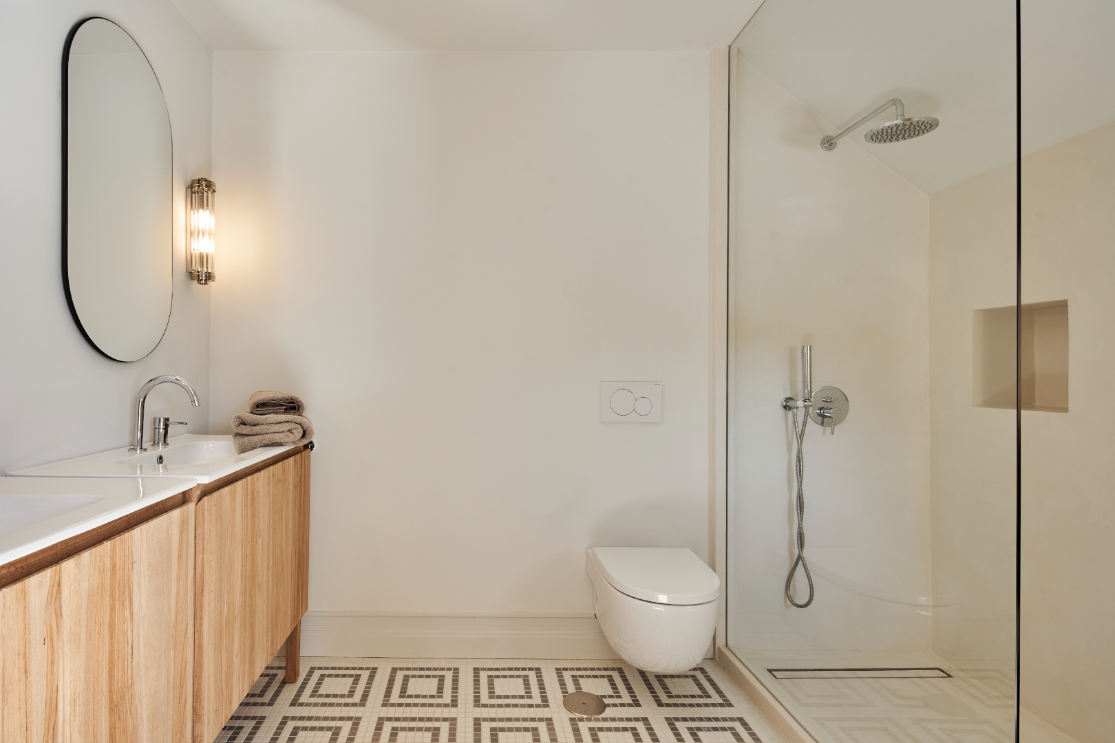 Bathroom — walk-in rain shower, oval mirror, mosaic tile, wall sconce
