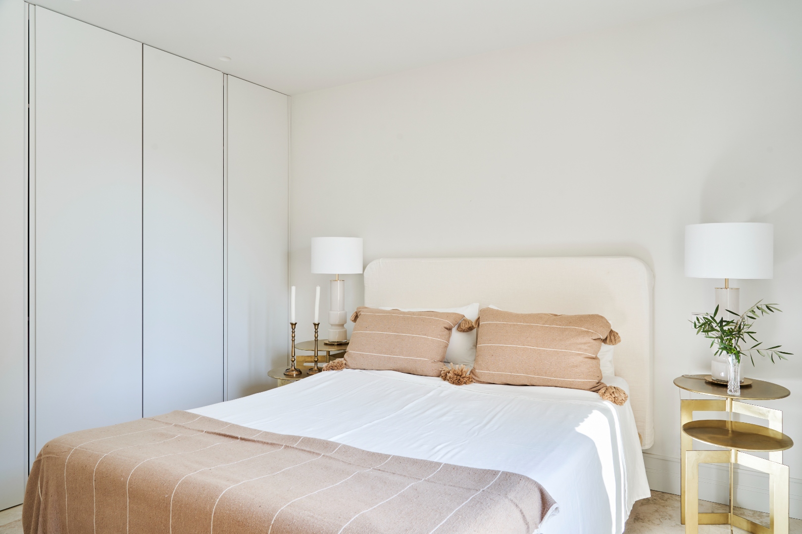 Second bedroom at Terraza Del Sol — queen bed, warm linen, brass side table, terrace door