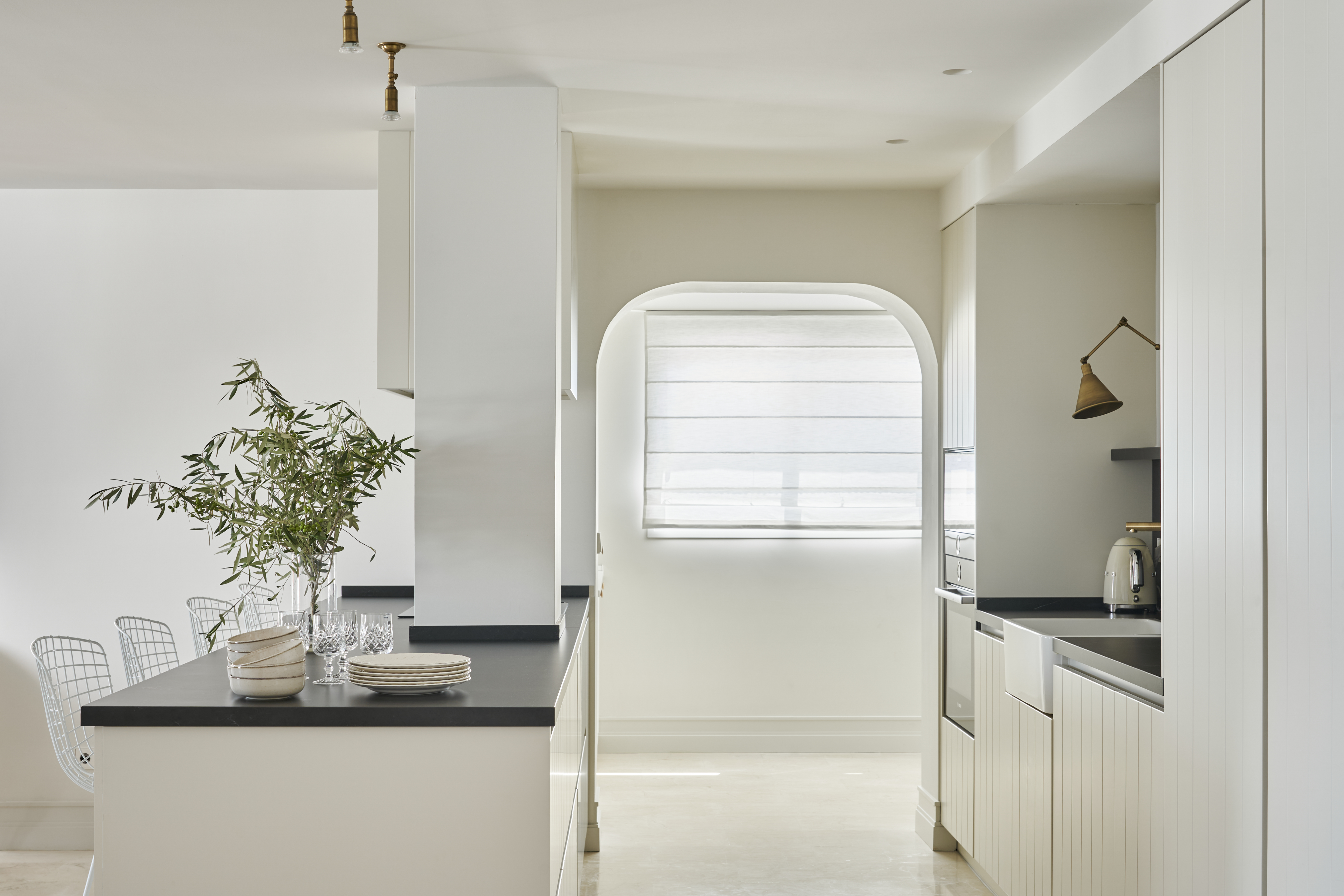 Kitchen detail at Terraza Del Sol — arched window, olive branch, island worktop