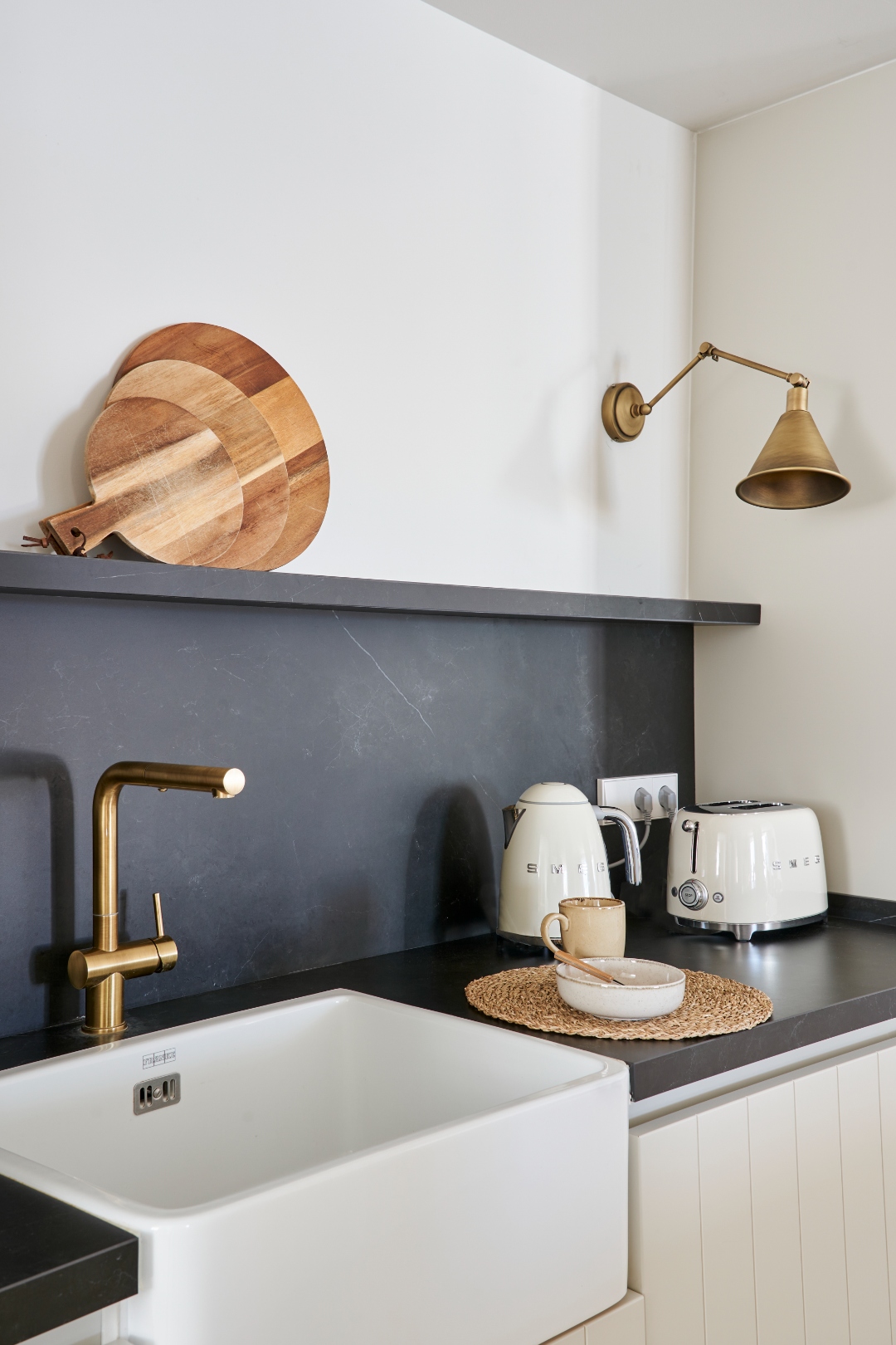 Kitchen at Terraza Del Sol — brass farmhouse tap, Smeg kettle and toaster, slate backsplash