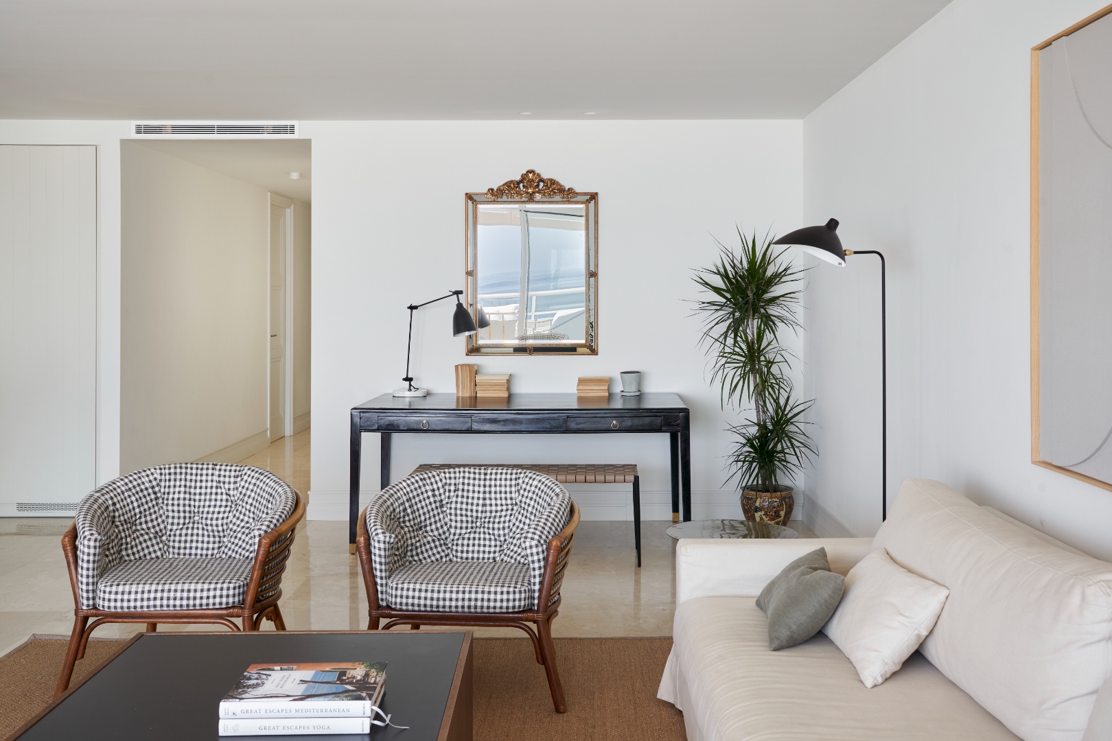 Living room — gingham chairs, gilt mirror, console table