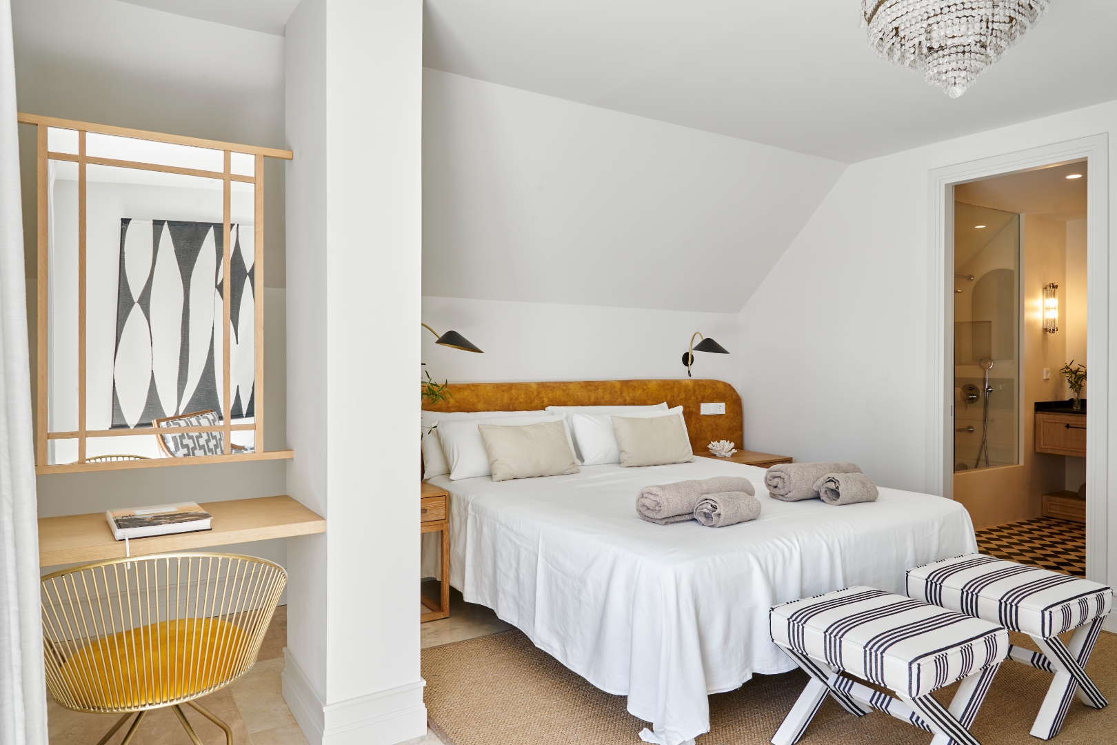 Master suite — king bed, crystal chandelier, en-suite glimpse