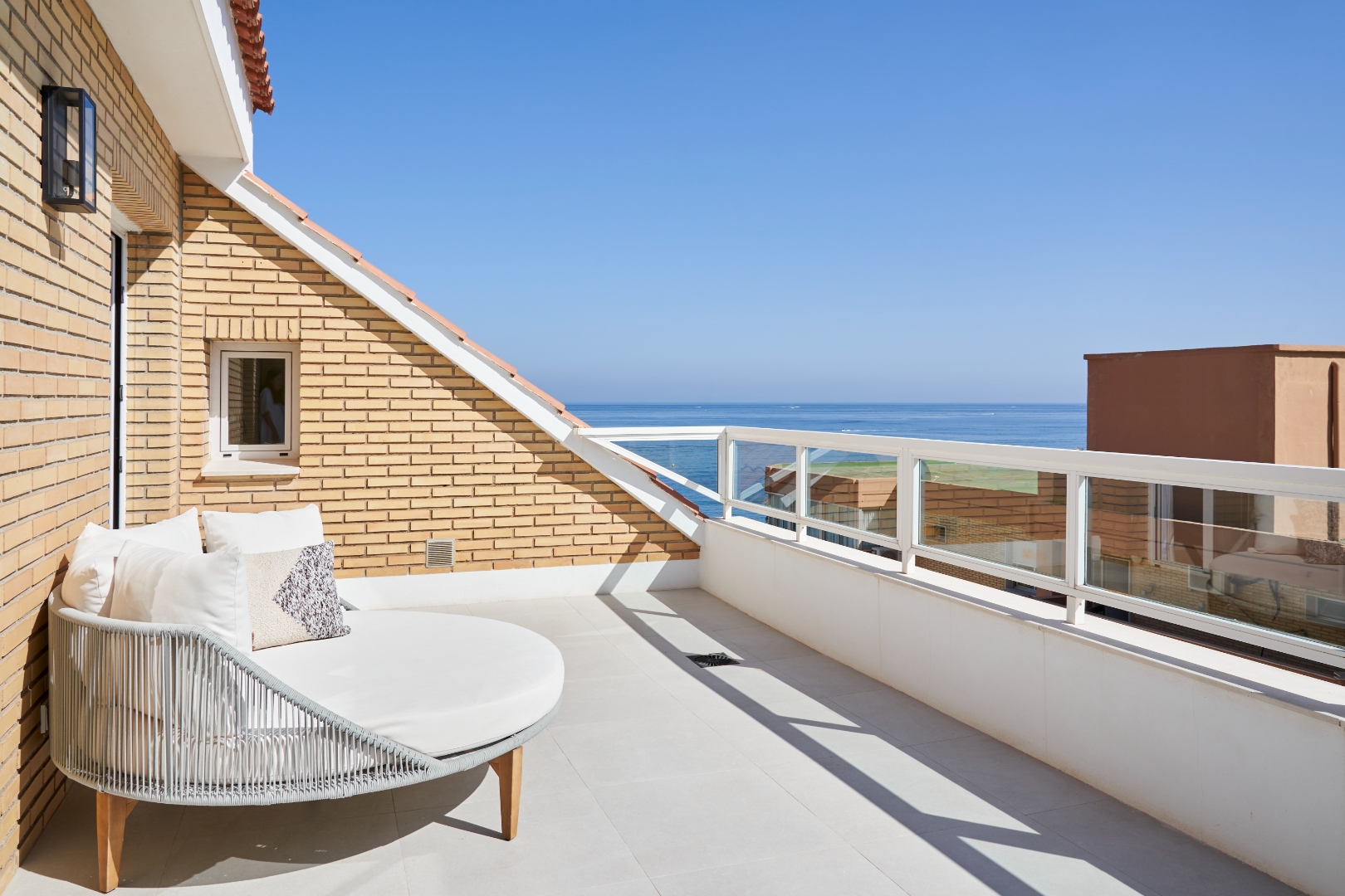 Master bedroom private terrace — round daybed, sea view