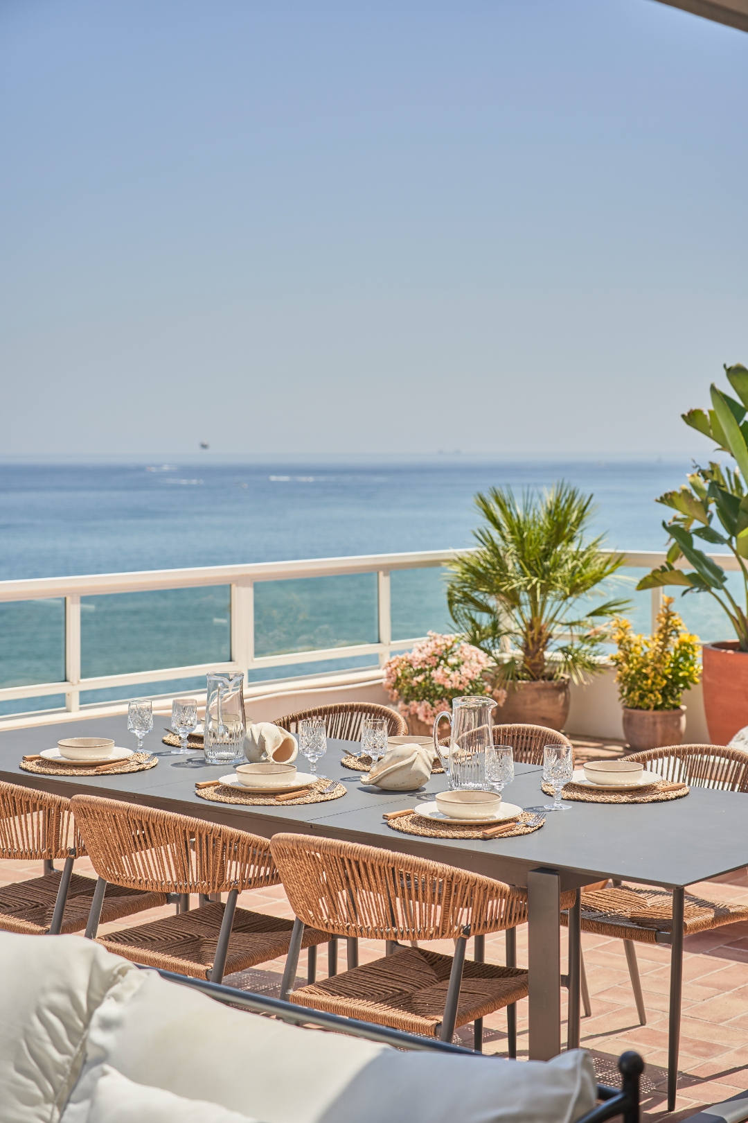 Terraza Del Sol terrace — lounge sofas and dining, Fuengirola city skyline beyond